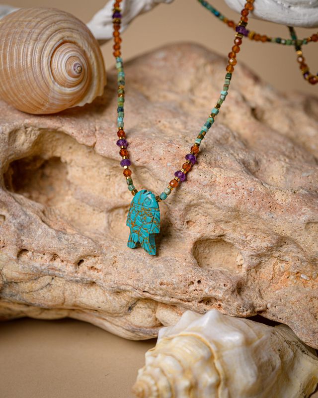 Turquoise fish with colorful neck stones